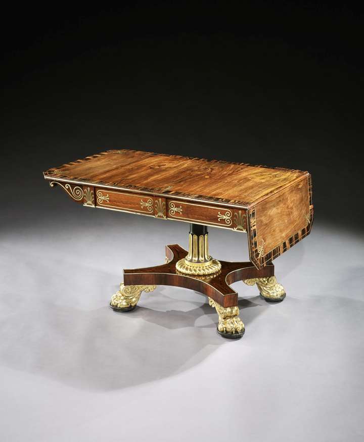 A regency parcel gilt brass inlaid rosewood sofa table